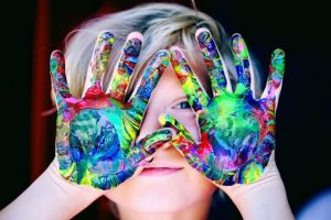 child-with-cloured-paint-on-hands