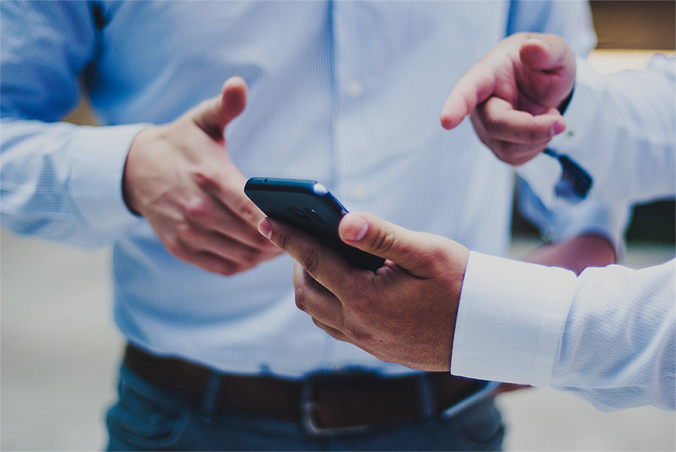 Image of one business man referring his colleague to a mobile application