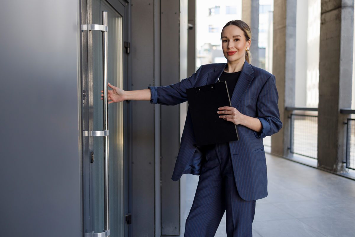 Woman holding door - door entry system