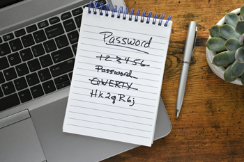 easily guessed passwords written on a pad on top of a laptop