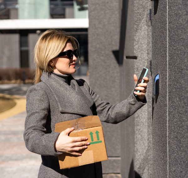 woman using a mobile phone to open a door