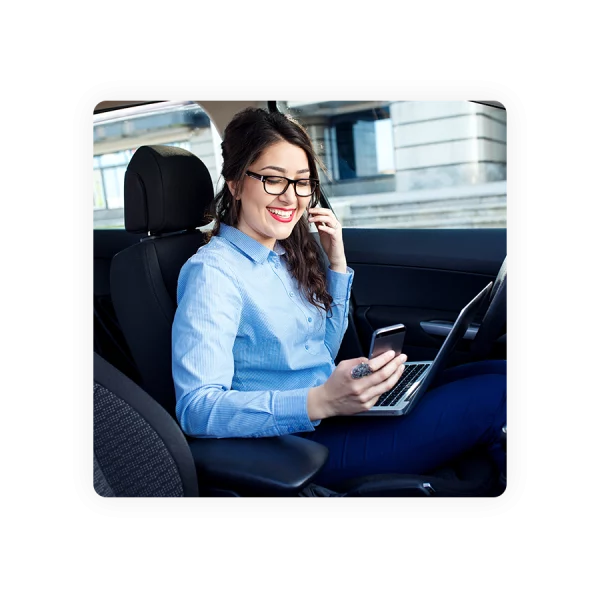 business woman in car not driving using phone to clock in