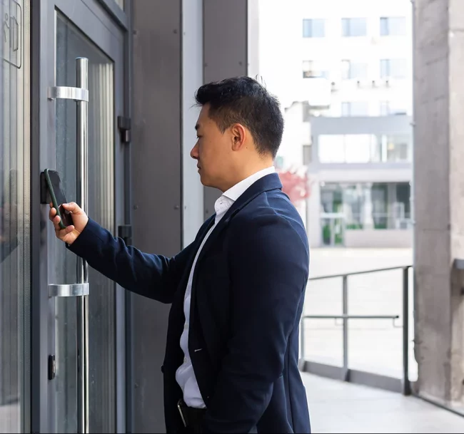 Business man opening a door with his smartphone