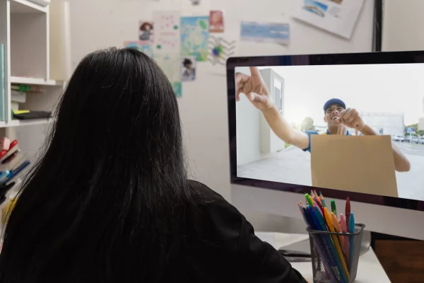 Woman in office reviewing intercom footage on a monitor