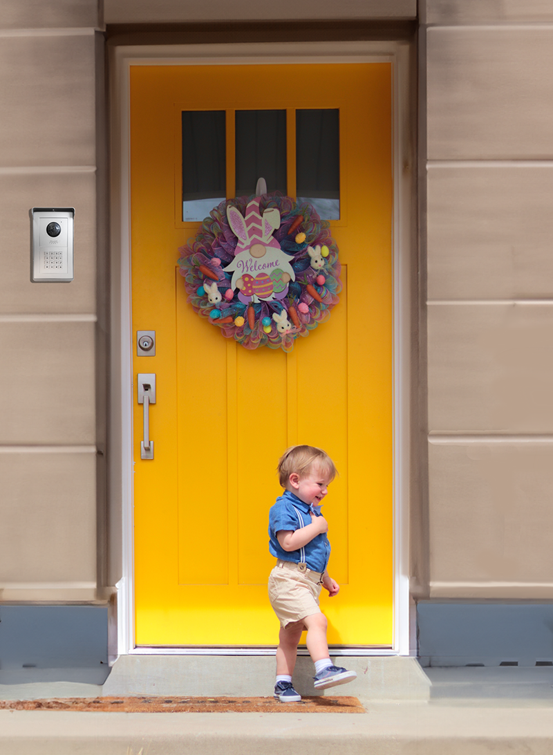 Little boy in front of a yellow nursery door